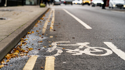 Worn Bicycle lane sign painted on road