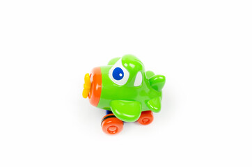 Small green toy airplane with eyes. Children's toy on a white background.