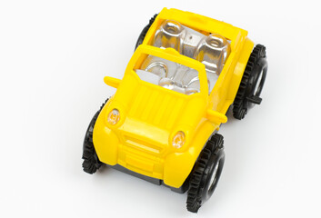 A yellow toy car with large black wheels on a white background.