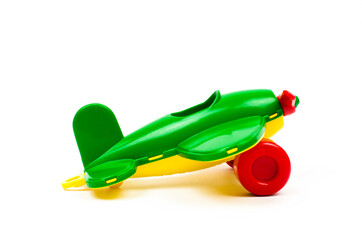 Children's toy plane of green color on a white background. Kids toys.