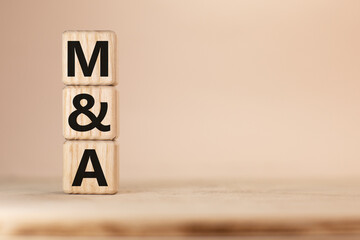 Close-up Shot of word M and A Merger and Acquisitionwooden blocks.