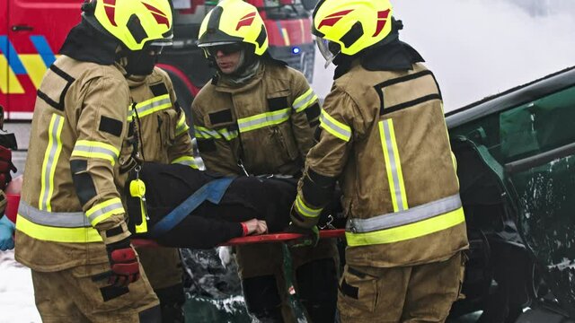 Firefighters rescuing person from car crash accident. High quality 4k footage