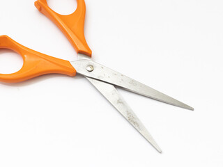 Orange scissor with white background.