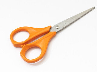 Orange scissor with white background.