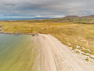 Aerial drone view on Silver strand beach in county Mayo, Ireland. Long sandy beach with beautiful views and peaceful atmosphere. Cloudy sky