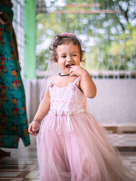 Cute Girl wearing pink fairytale dress stock image.
