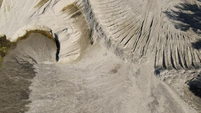 Drone view to sand quarry with tire tracks.