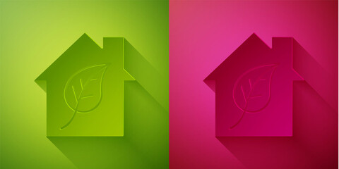 Paper cut Eco friendly house icon isolated on green and pink background. Eco house with leaf. Paper art style. Vector.