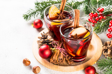 Mulled wine with christmas decorations on white.