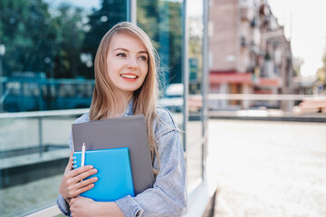 Girl student smiling and looking to the side at copy space for text
