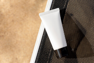 Sun protection cosmetics. Body lotion or cream tubes with UV protection and moisturizing effect on sandy beach background. Packaging design. Cosmetics mock up. White tube of cream. Healthy sunbathing