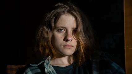 Close-up portrait of a european girl in a shirt with piercings