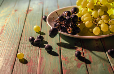 Fresh natural grapes on a plate in the morning sunlight