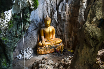 The golden Buddha statue in Pha Joh Cave mountain (The new attraction) in Nongbualamphu Province, Thailand 