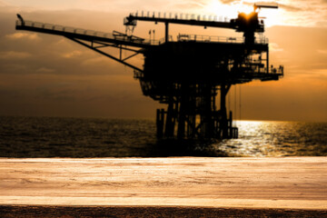 An empty wooden table with Oil and Gas production platform