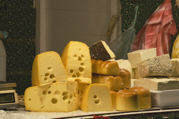 Various types of farm cheese on holiday market stall in Timisoara, Romania - obrazy, fototapety, plakaty