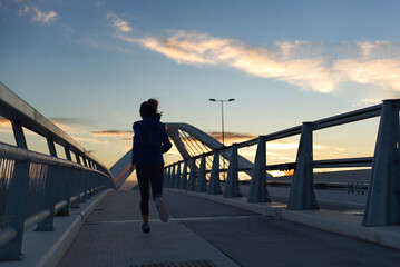 Woman running very early in the morning, in Barcelona, Spain.