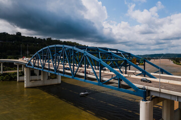 Fototapeta premium This is an aerial of a blue, eight-lane highway arch bridge that carries Interstate 64 over the Kanawha River in Charleston, West Virginia.