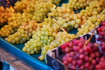 Large heap of fresh ripe organic grapes on farmer market in Paris