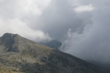 The peaks in mountain Pirin on background of dramatic sky storm clouds