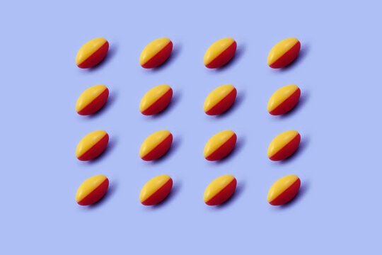Red and yellow capsule Pharmaceutical medicine tablet on a Blue background,Medicine creative concepts. Minimal style with colorful paper backdrop.Trendy colors,Trendy pattern