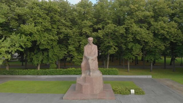 Aerial circle pan around Rainis statue in Esplenade park, Riga, Latvia
