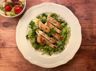Tender grilled chicken strips served over mixed salad with balsamic dressing. 