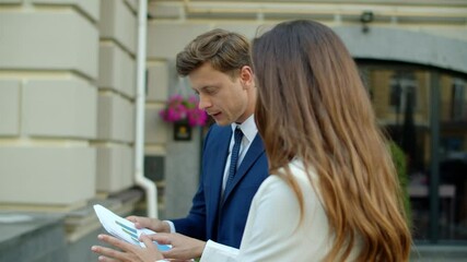 Disappointed professional criticizing business documents outdoors - Powered by Adobe