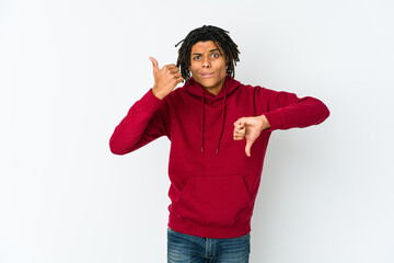 Young african american rasta man showing thumbs up and thumbs down, difficult choose concept