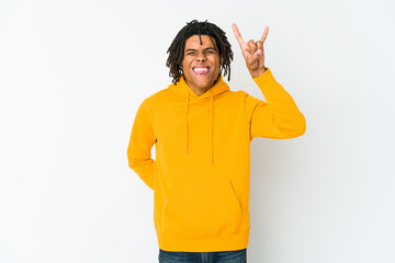Young african american rasta man showing rock gesture with fingers