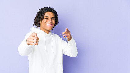 Young african american rasta man pointing to front with fingers.