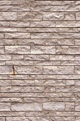 Sandstone brick wall. Vertical background texture. 