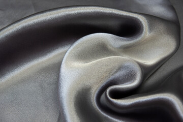The texture of the silk fabric is silver-blue. Chiffon. Background, pattern.