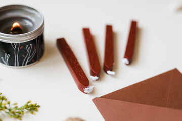 brown envelope candle and stamp with sealing wax on the table