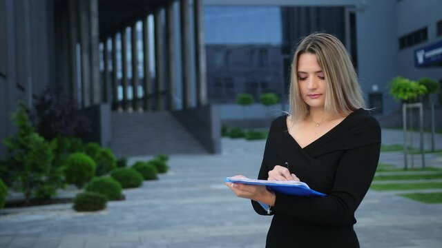 Woman hands signs contract. Businesswoman puts signature to partnership agreement concept. Female entrepreneur accepts conditions of deal. Working with business documents outside. signing document pen