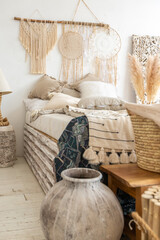 Large spacious room with a trendy loft design of sitting area. huge windows and stylish wicker light furniture inside. an abundance of ethnic decor