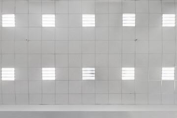 cassette suspended ceiling with square halogen spots lamps and drywall construction in empty room...
