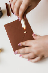 sealing wax is dropped on the brown envelope for printing