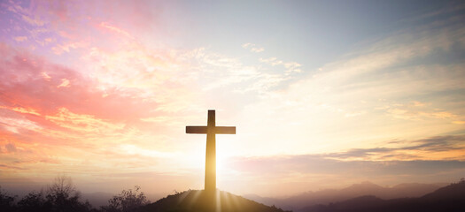 Fototapeta na wymiar Christian cross concept: Silhouette cross on mountain sunset background