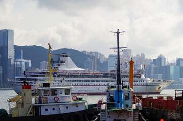 Run down cruiseship or cruise ship liner servicing as floating casino in Victoria Harbor bay in...