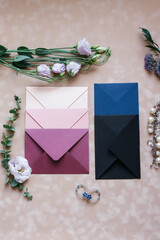 pink and blue mother-of-pearl envelopes on a background of velvet paper