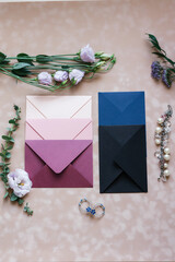 pink and blue mother-of-pearl envelopes on a background of velvet paper