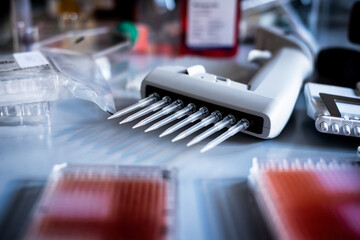 Multichannel pipette loading samples in pcr microplate with 96 wells / Multi channel pipette...