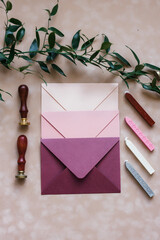 pink mother-of-pearl envelopes on a background of velvet paper