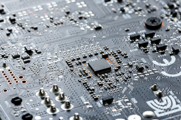 Electronic PCB printed circuit board in macro close-up with transistors circuitry and electric...