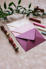 pink mother-of-pearl envelopes on a background of velvet paper