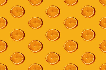 Orange seamless pattern. Yellow abstract background. Citrus aroma spice. Natural decor creative composition. Round cut dry fruit slices minimalist arrangement isolated on bright color.