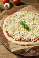 Preparing Homemade Uncooked Cheese PIzza