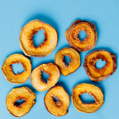 slices of dried persimmon on a blue background. dried fruits. eco.