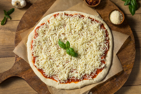 Preparing Homemade Uncooked Cheese PIzza